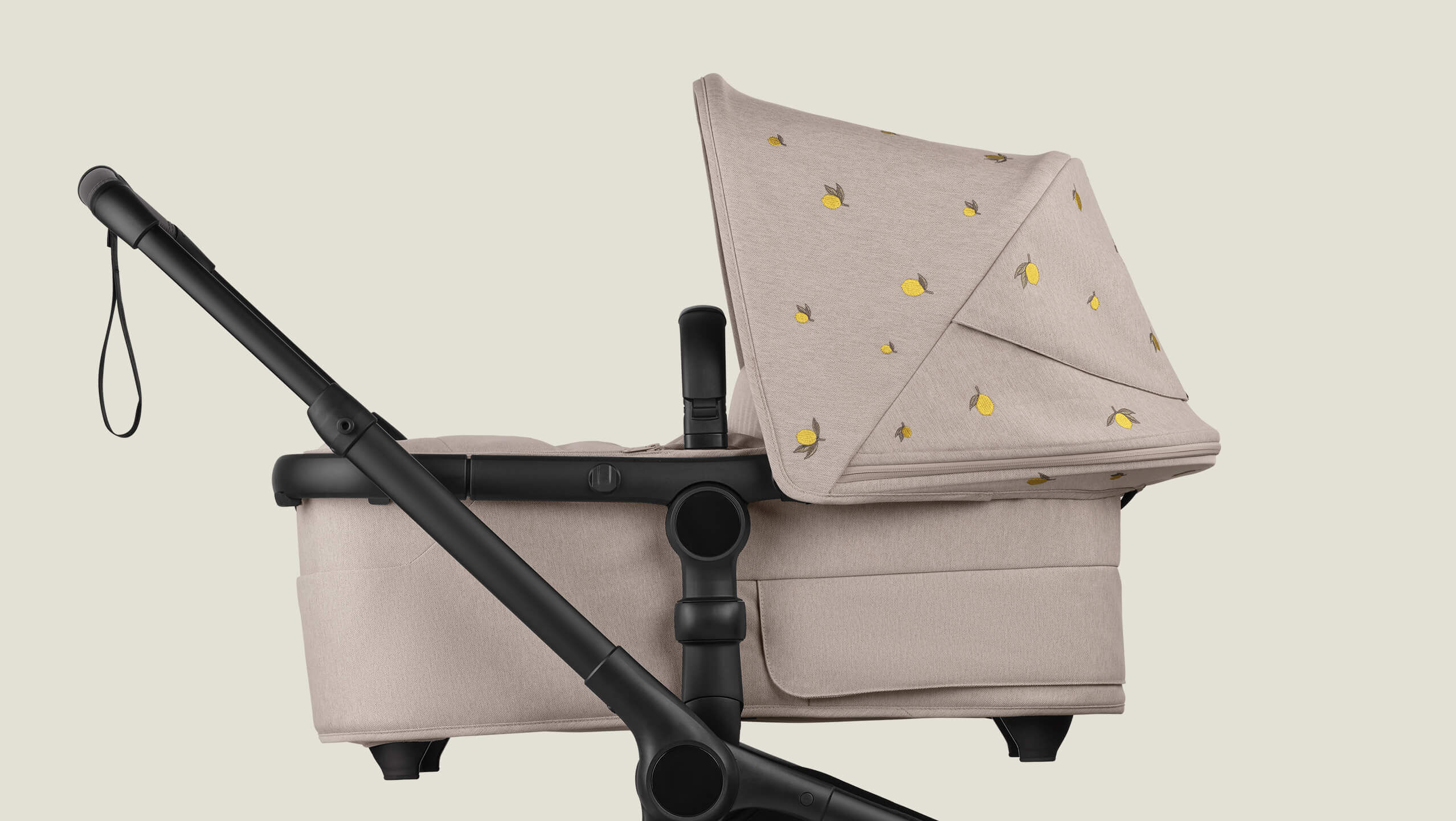 A Bugaboo Fox 5 Renew bassinet stroller with Bugaboo X Konges Sløjd Limited Edition sun canopy, featuring Konges Sløjd's signature lemon print.