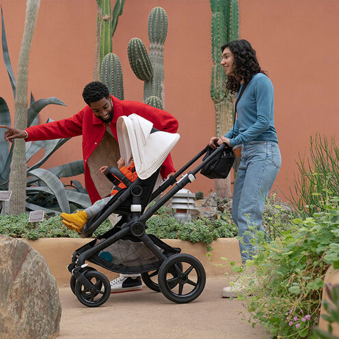 Man and woman pushing stroller