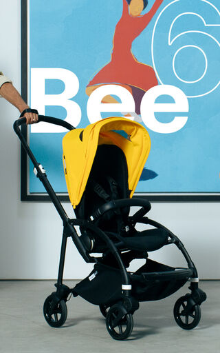 Bugaboo Bee 6 city stroller with yellow sun canopy.