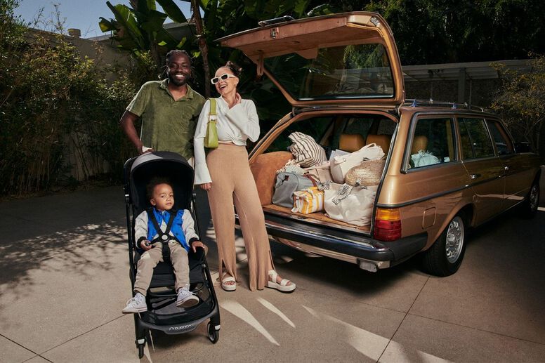 Parents pushing their baby in a lightweight stroller