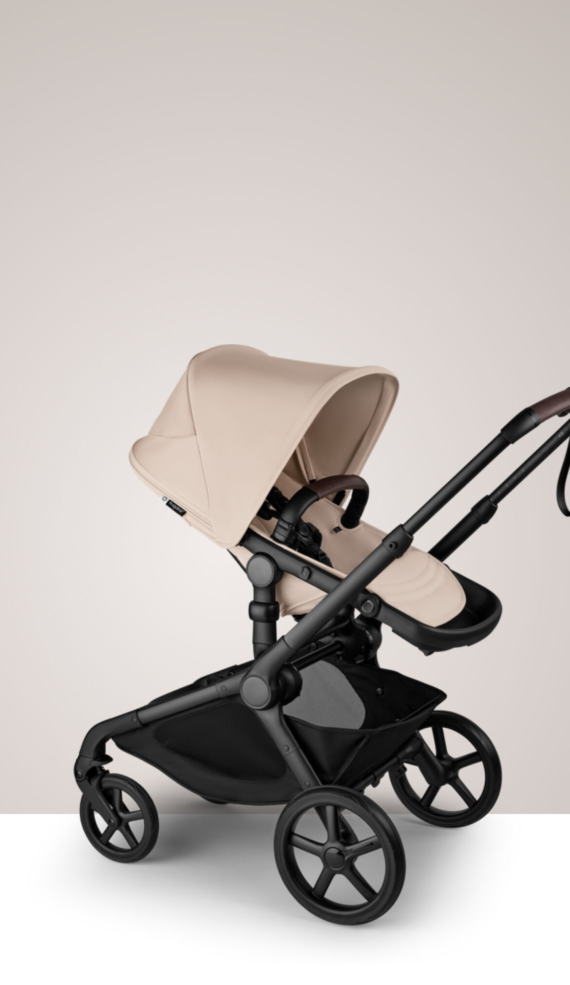 A Bugaboo Kangaroo single-to-double stroller in Desert Taupe fabrics, with a bassinet.