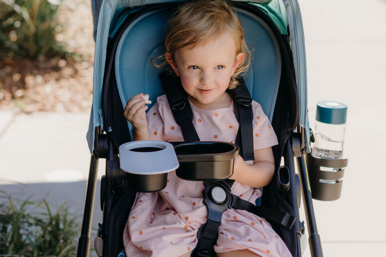 Baby eating in stroller