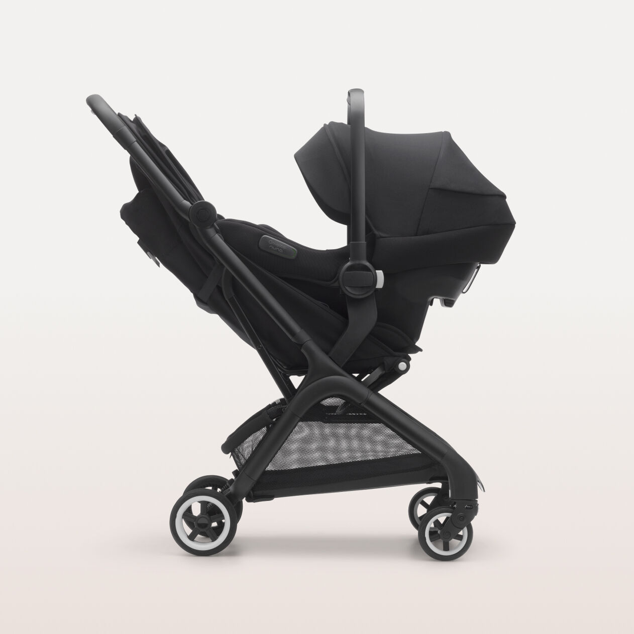 Side view of the Bugaboo Turtle Air Shield by Nuna car seat installed on a Bugaboo seat stroller.