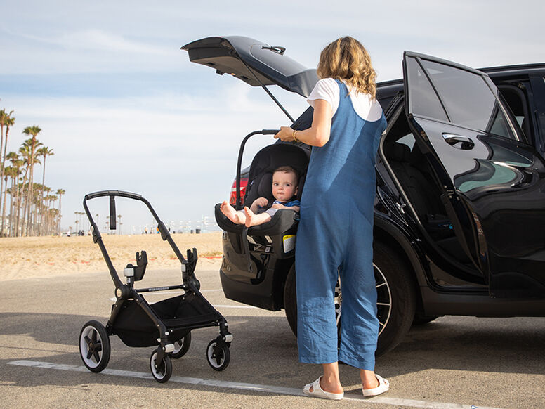 Mom holding baby in car seat