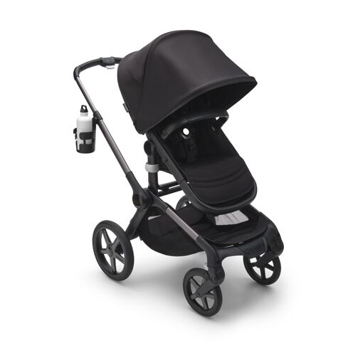 A green bottle in a Bugaboo cup holder on a stroller.