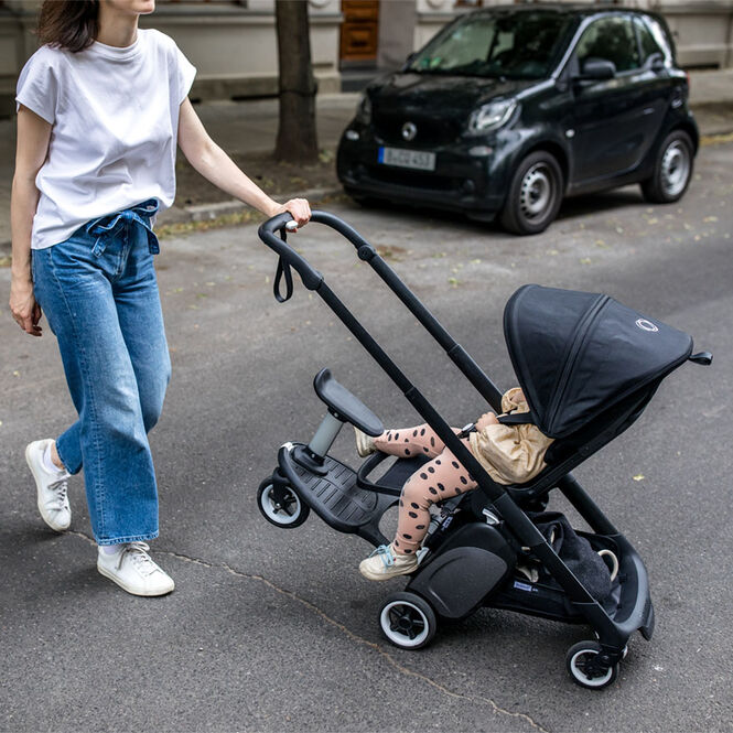 Woman pushing Ant stroller with one hand