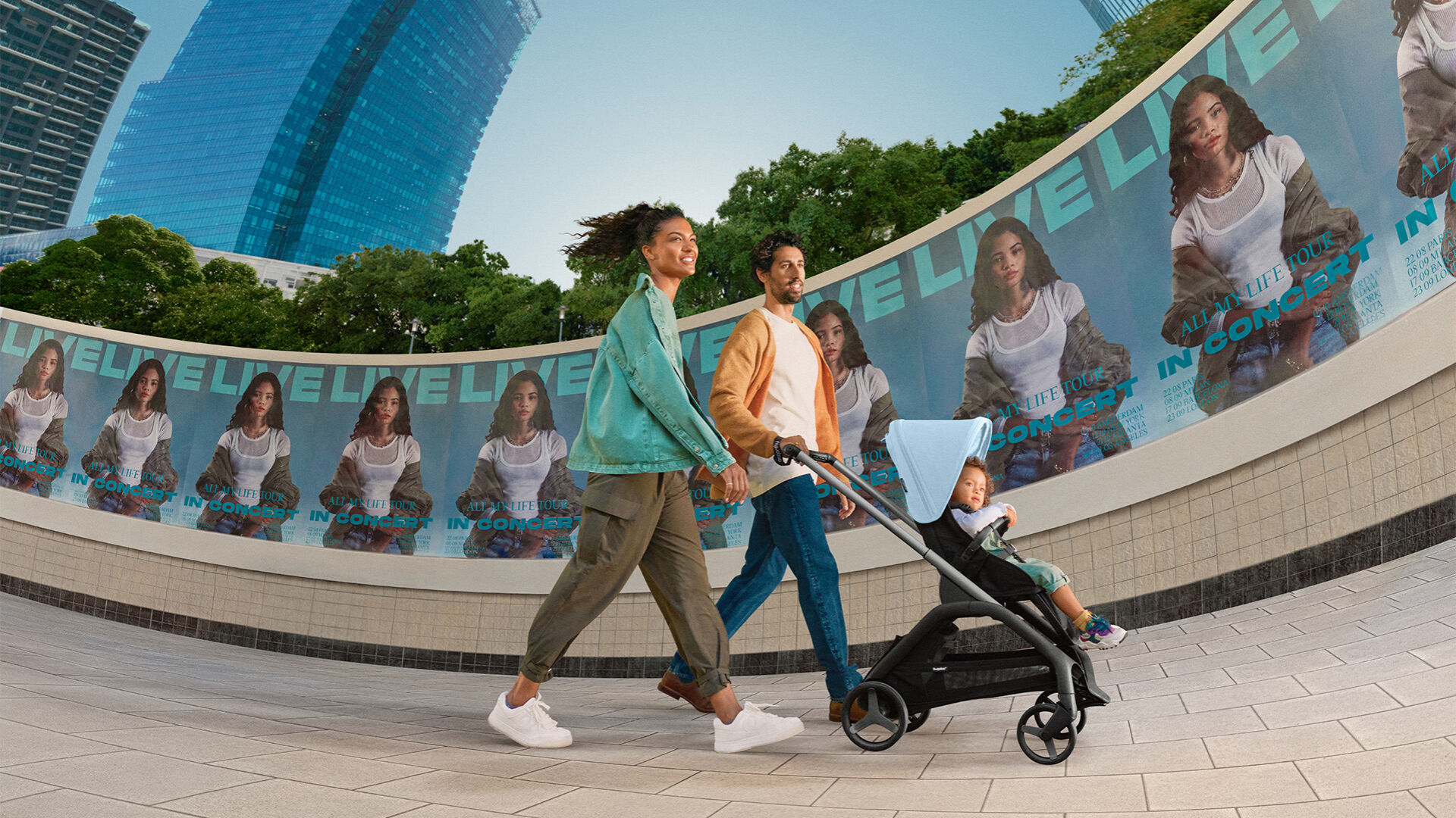 Parents strolling with toddler sitting in the Bugaboo Dragonfly stroller.