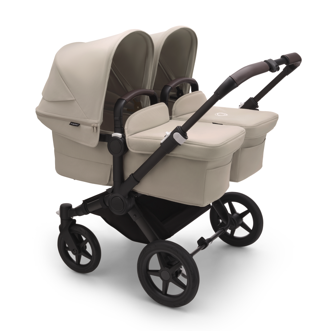The Bugaboo Donkey 5 with Desert Taupe fabrics in Twin configuration, featuring two bassinets side by side.