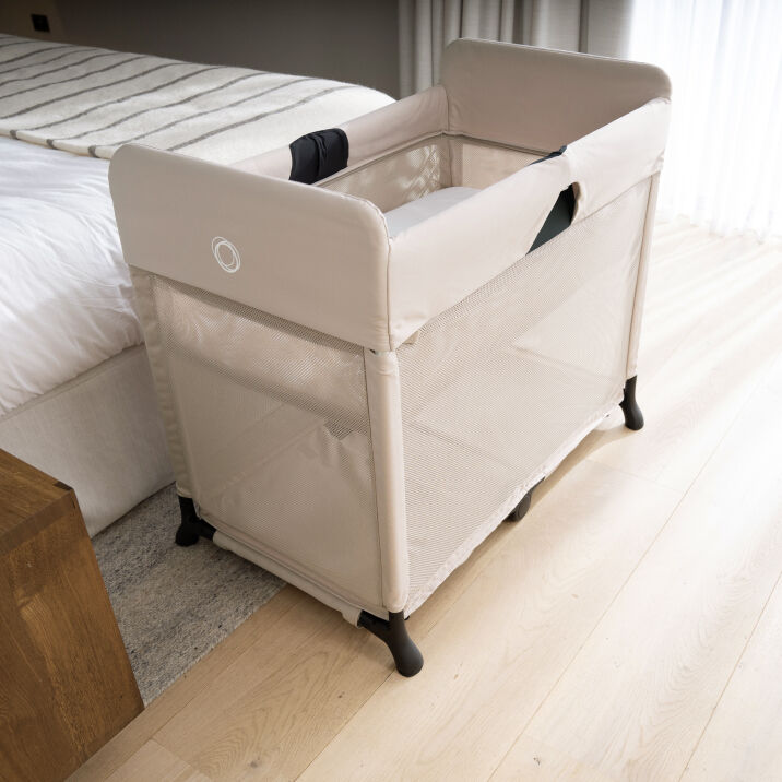 The Bugaboo Stardust play yard in Desert Taupe inside a sunlit bedroom.