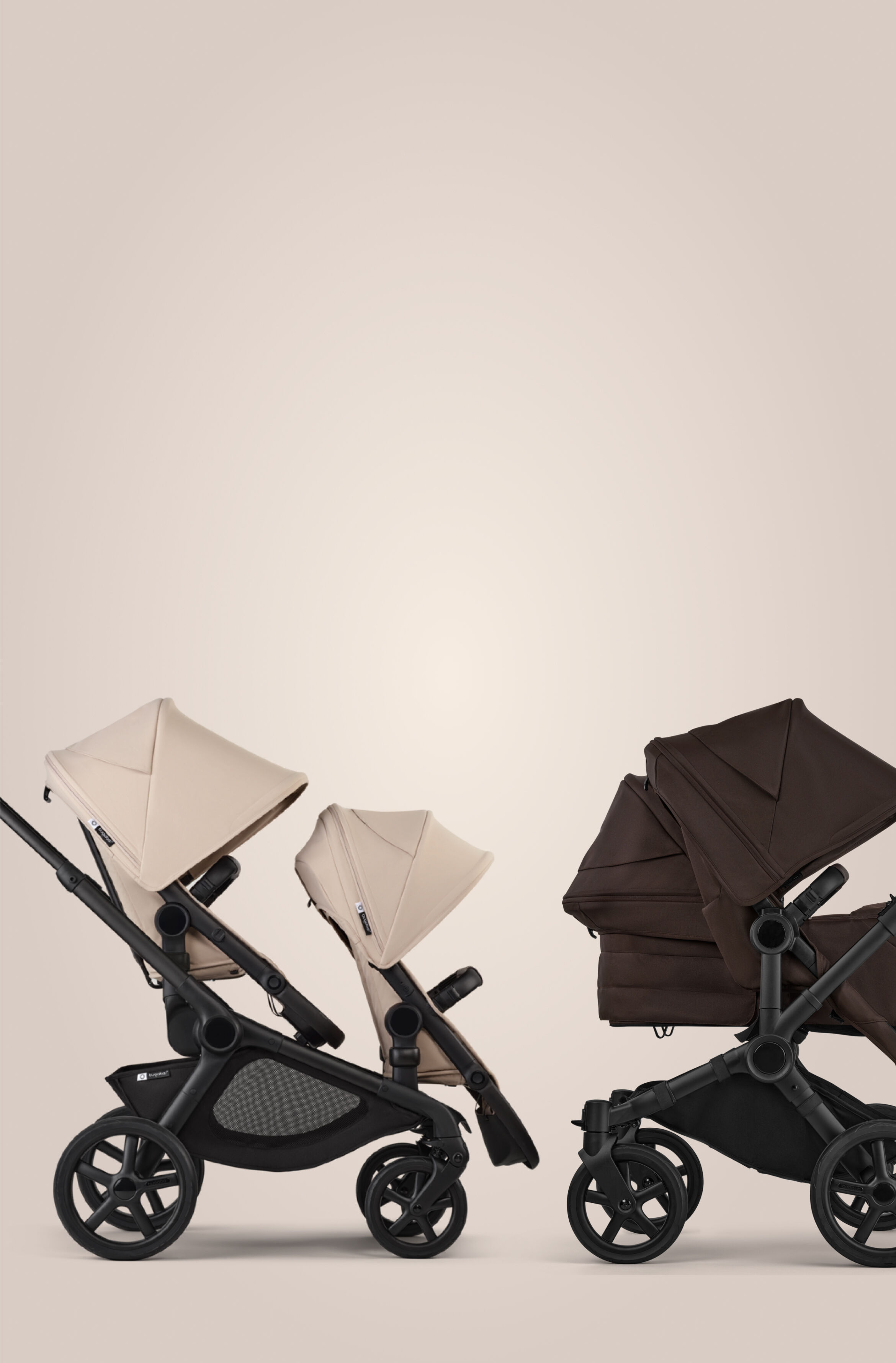 Two Bugaboo strollers in a row. On the left, a Bugaboo Kangaroo tandem stroller with two seats, in Desert Taupe fabrics. On the right, a Bugaboo Donkey 6 double stroller with a seat and a bassinet, in Cocoa Brown fabrics.