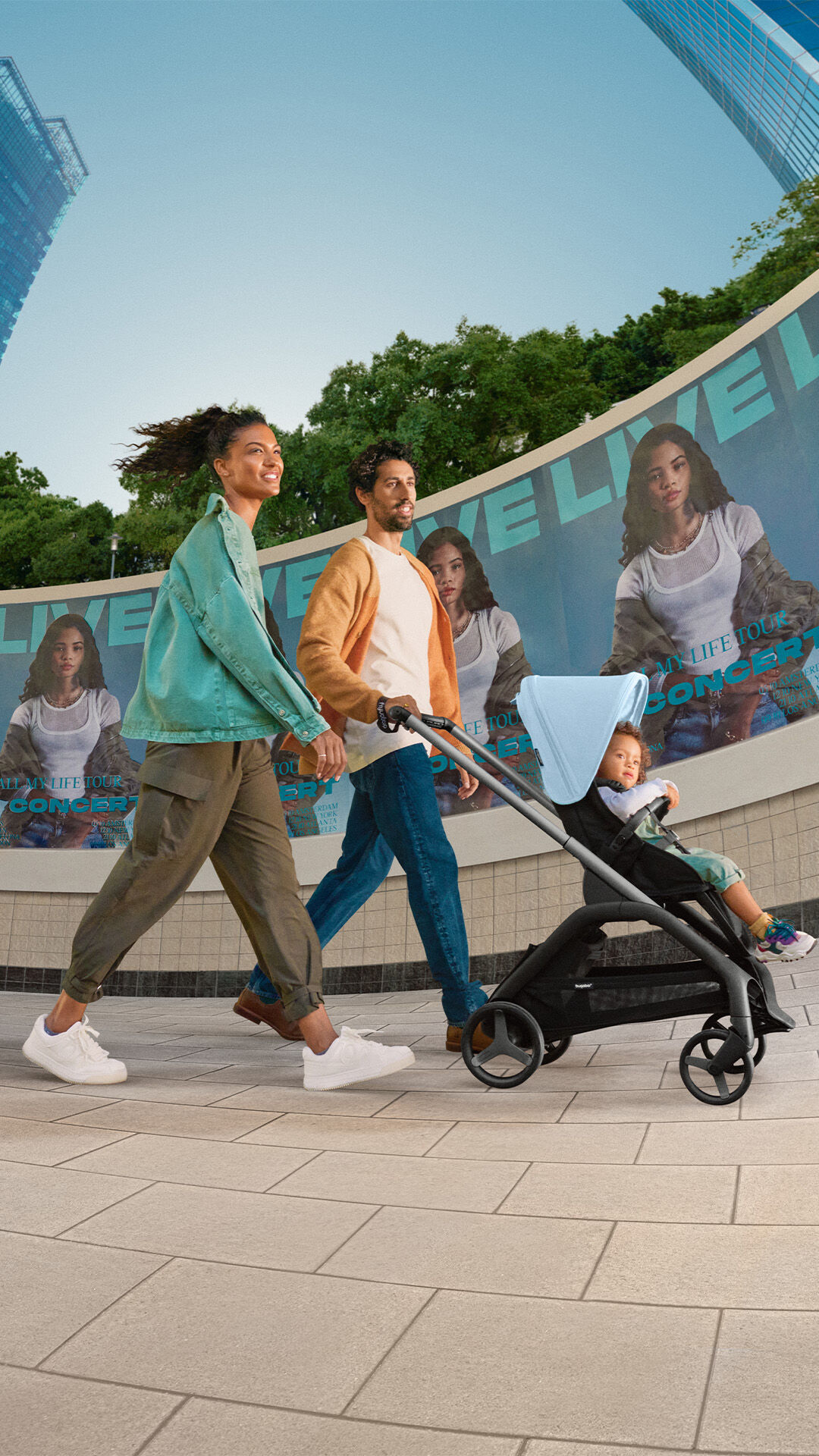 Parents strolling with toddler sitting in the Bugaboo Dragonfly pushchair.