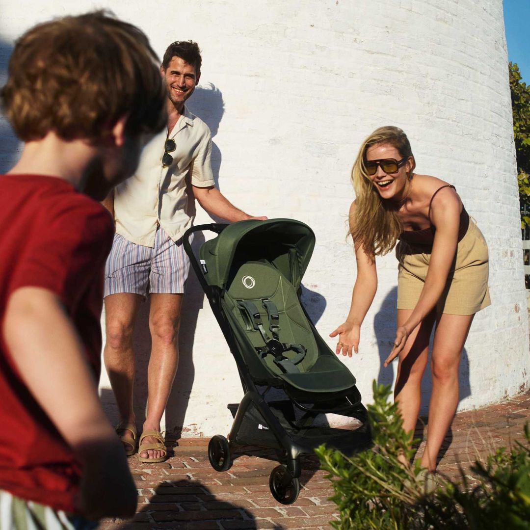 Two parents playing with their children and the Bugaboo Butterfly 2 stroller.