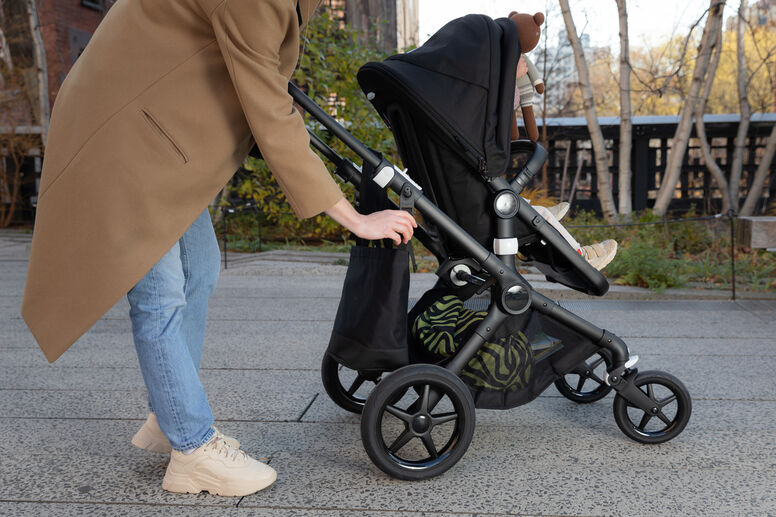 Mom putting bag on stroller