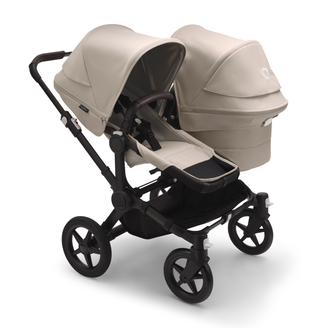 The Bugaboo Donkey 5 with Desert Taupe fabrics in Duo configuration, featuring a seat and a bassinet side by side.