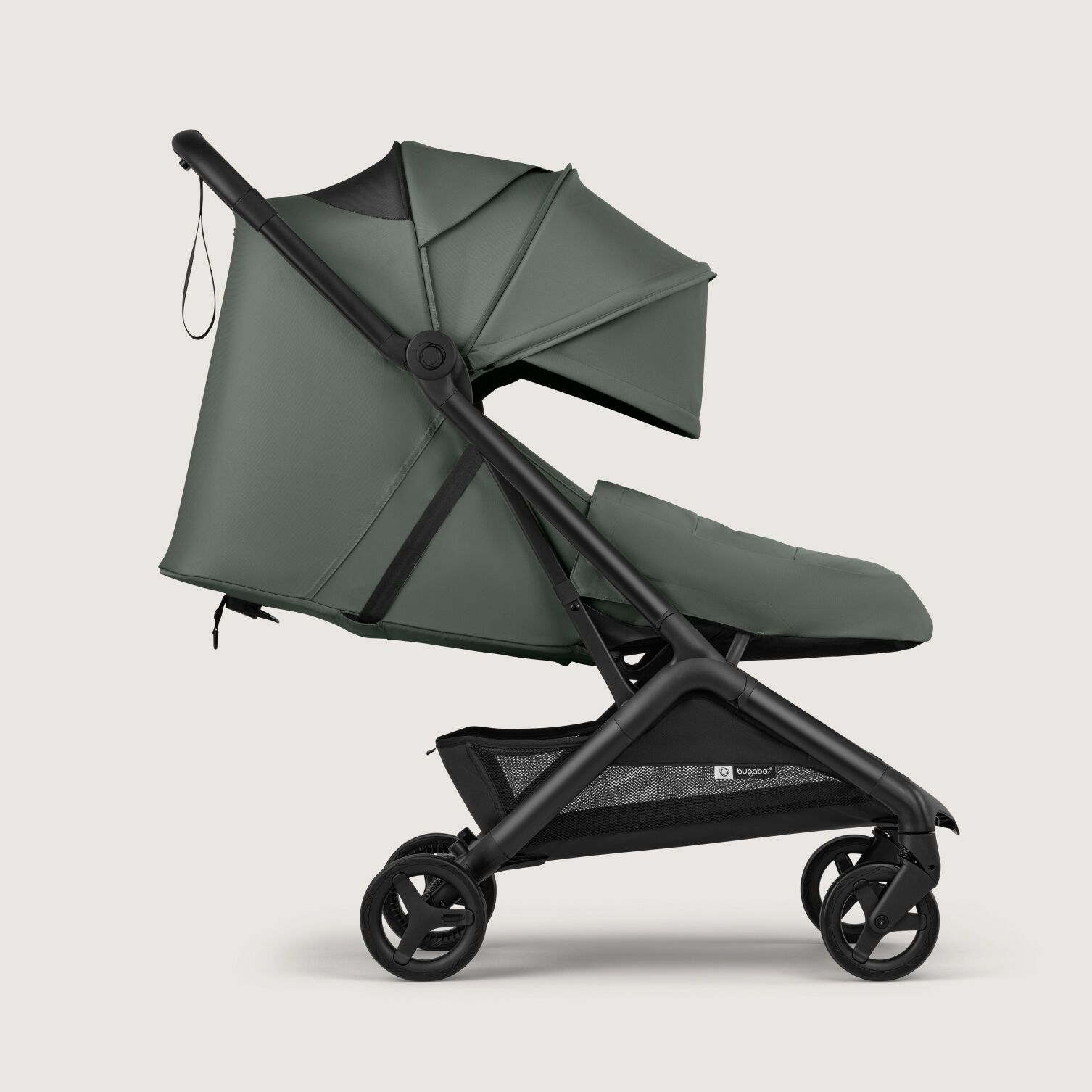 The Bugaboo Butterfly 2 Plus travel stroller in green fabrics, showing the lay-flat seat and the built-in newborn foot cover.