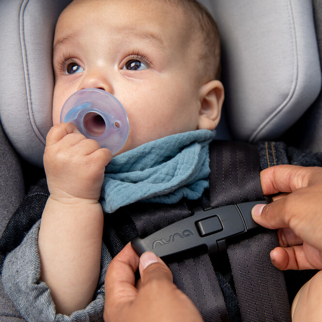 Baby in the Turtle Air by Nuna car seat.