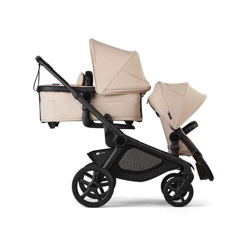 A Bugaboo Kangaroo stroller with a bassinet and a seat in Desert Taupe fabrics.