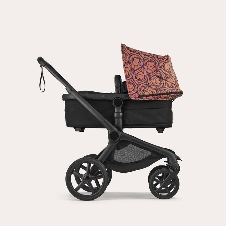 Alt text  Side view of a Bugaboo Fox 5 Renew stroller with a bassinet and a Bugaboo X Artipoppe Limited Edition sun canopy.