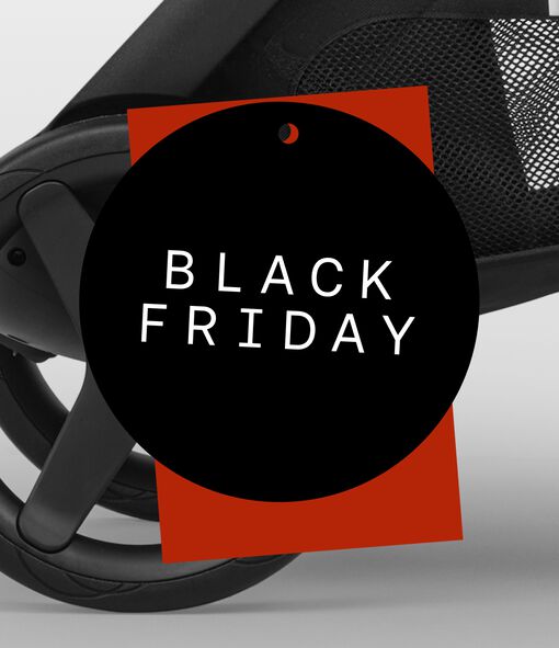 Close-up of a Bugaboo stroller wheel, below a red price-tag shape. On top is a black circular badge with the words “Black Friday” in white.