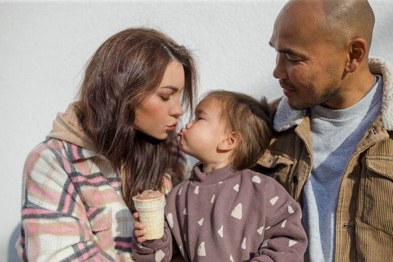 Mom and dad looking at baby eating