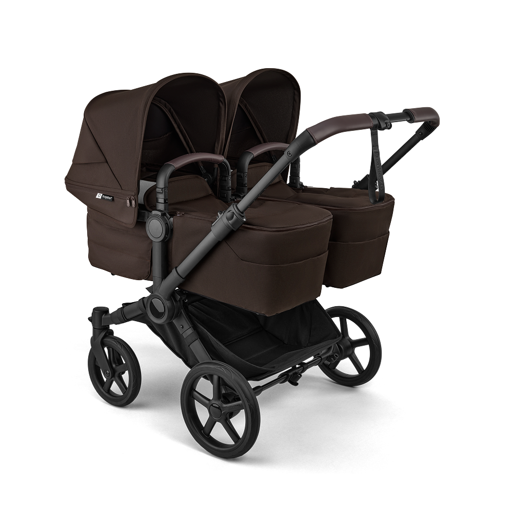 A Bugaboo Donkey 6 stroller in twin configuration, featuring two bassinets. The fabrics are in Cocoa Brown.