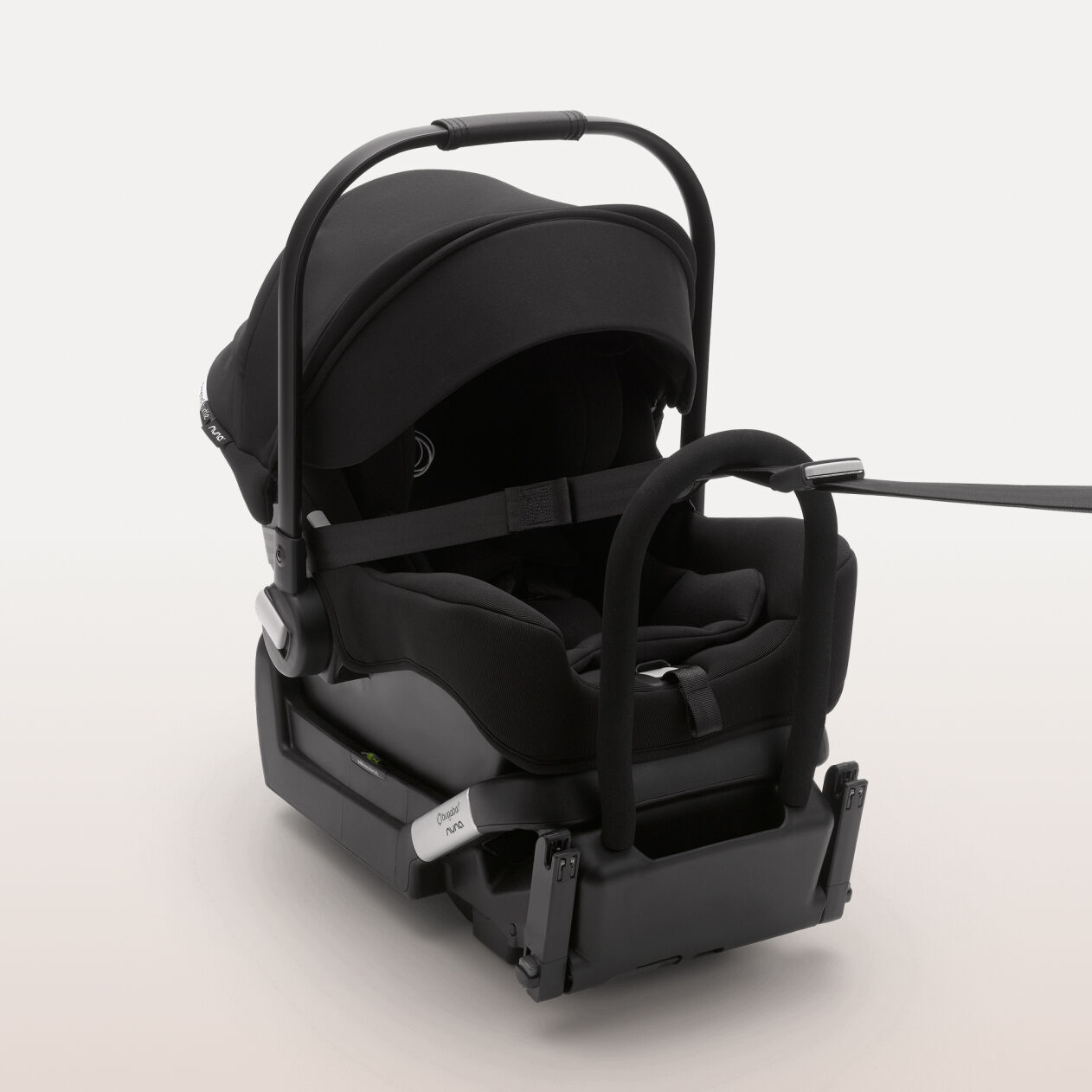 A Bugaboo Turtle by Nuna car seat attached on an ISOFIX base and tied to a tether strap.