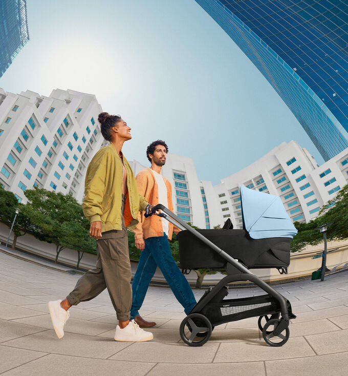 Parents taking a Bugaboo Dragonfly city stroller out on a stroll.	 	 	