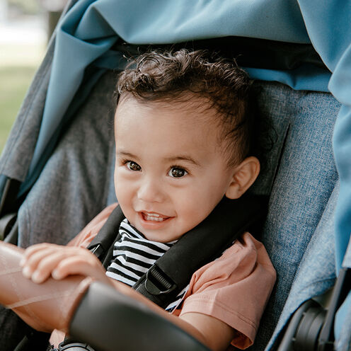 Smilling toddler in a Lynx stroller.