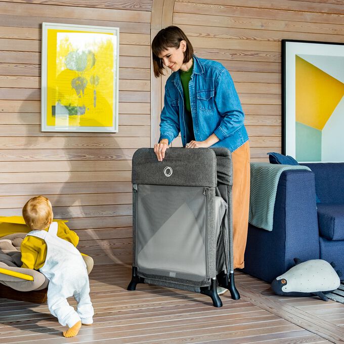 A Bugaboo Stardust travel cot in grey.