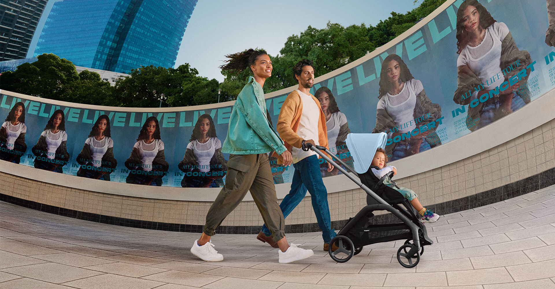 Couple walking with child in Bugaboo Dragonfly seat stroller
