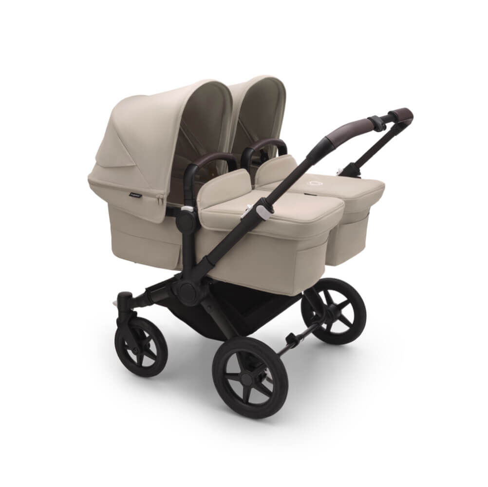 The Bugaboo Donkey 5 with Desert Taupe fabrics in Twin configuration, featuring two bassinets side by side.
