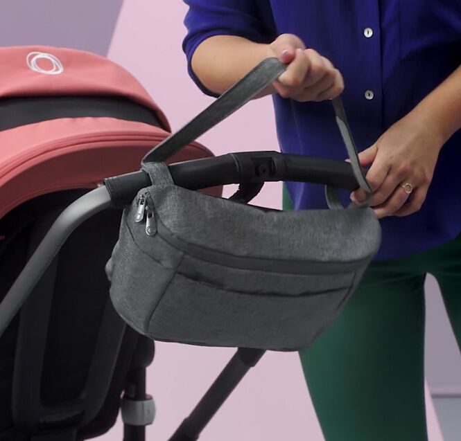 Bugaboo organizer securely attached on the stroller's handlebar.