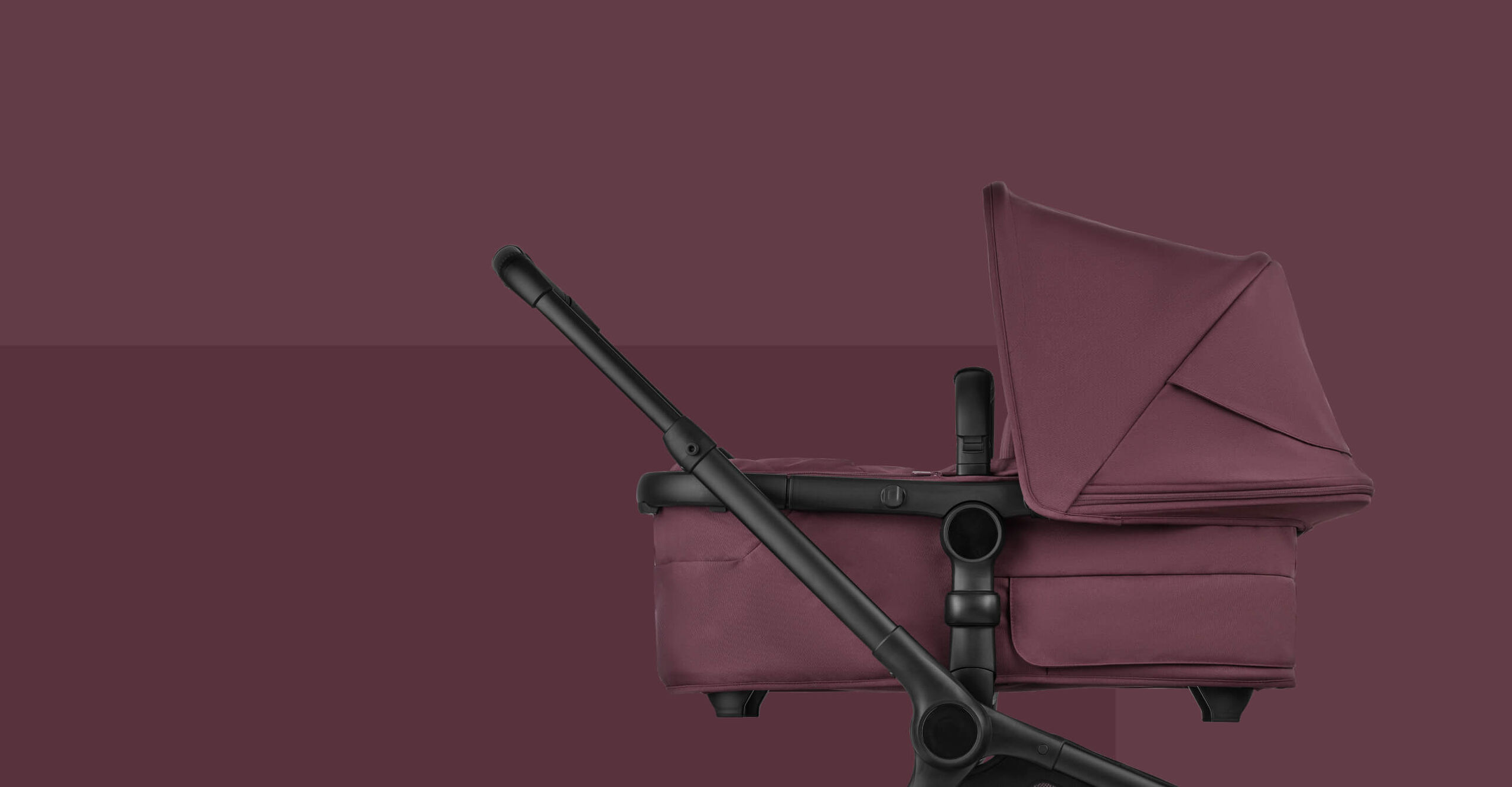 A Bugaboo Fox 5 Renew bassinet pushchair in Dark Cherry colorway, placed on a magenta background.