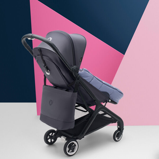 A Bugaboo stroller with the Bugaboo footmuff and Bugaboo changing bag.