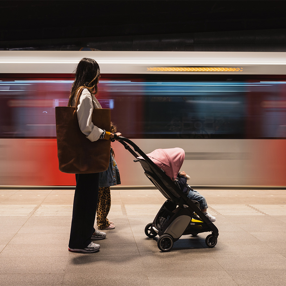 Woman waiting for subway with Ant stroller