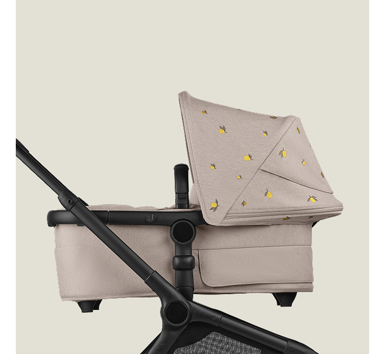 A Bugaboo Fox 5 Renew bassinet stroller with Bugaboo X Konges Sløjd Limited Edition sun canopy, featuring Konges Sløjd's signature lemon print.