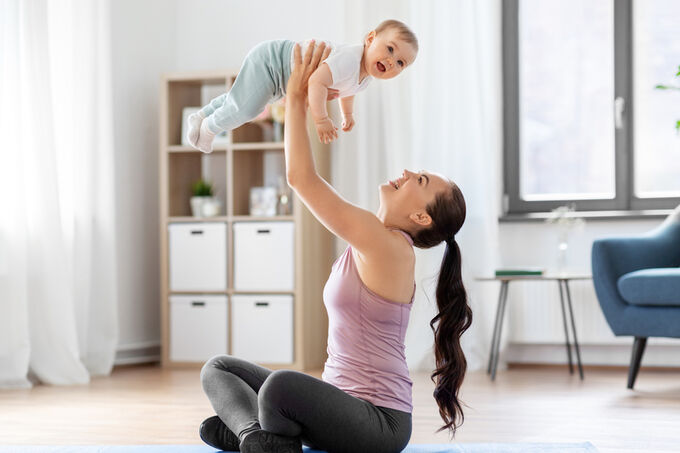Mother exercising with her baby