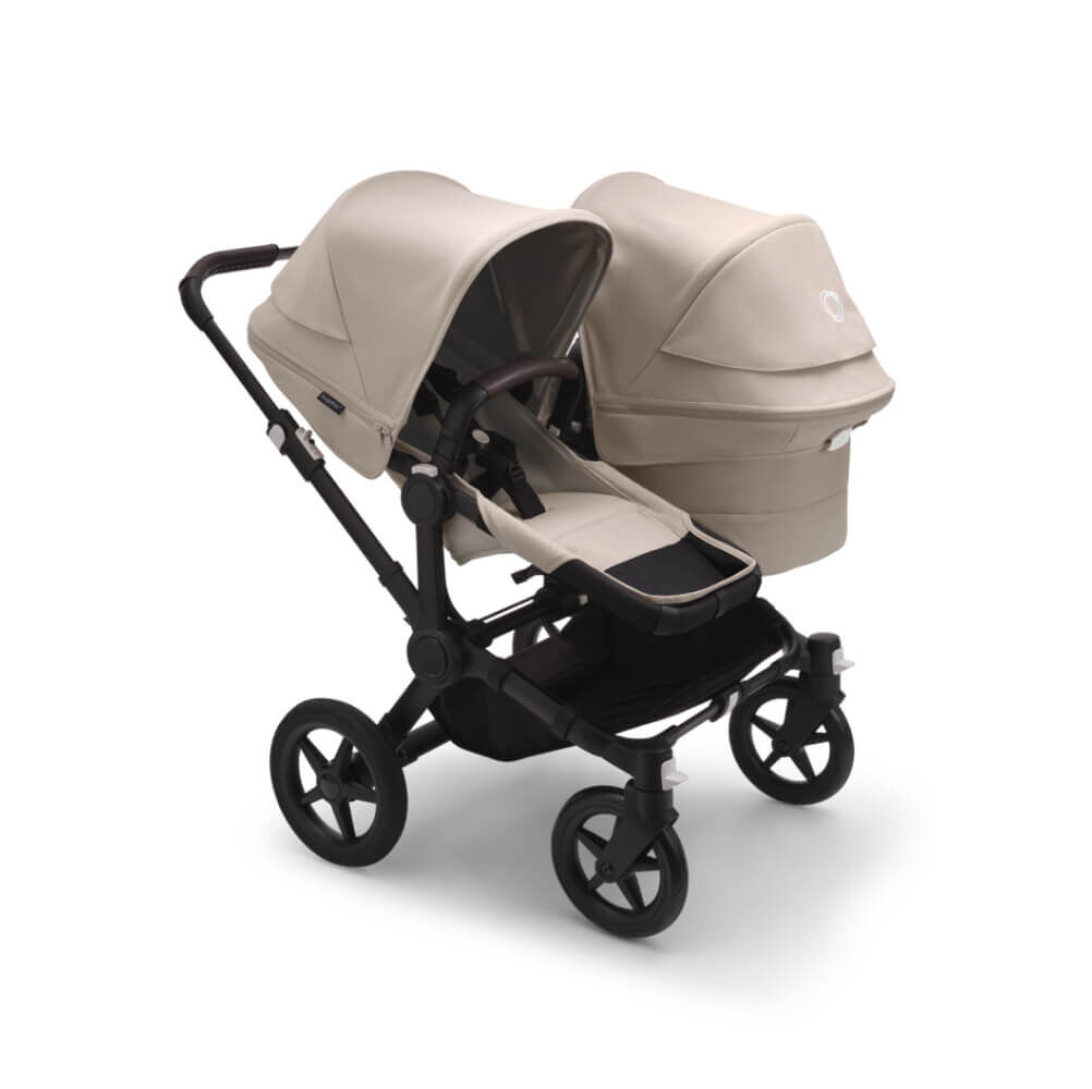 The Bugaboo Donkey 5 with Desert Taupe fabrics in Duo configuration, featuring a seat and a bassinet side by side.