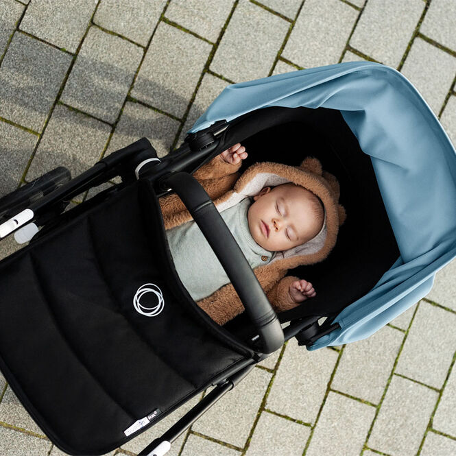 Baby napping in a stroller