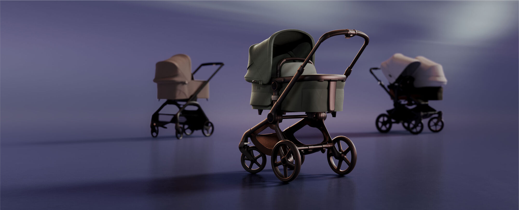 A lineup of 3 newborn strollers. At the front is a Bugaboo Fox 5 with Forest Green fabrics; further back are a Bugaboo Fox 5 with Dune Taupe fabrics and a Bugaboo Donkey 5 Duo with Misty White sun canopy.
