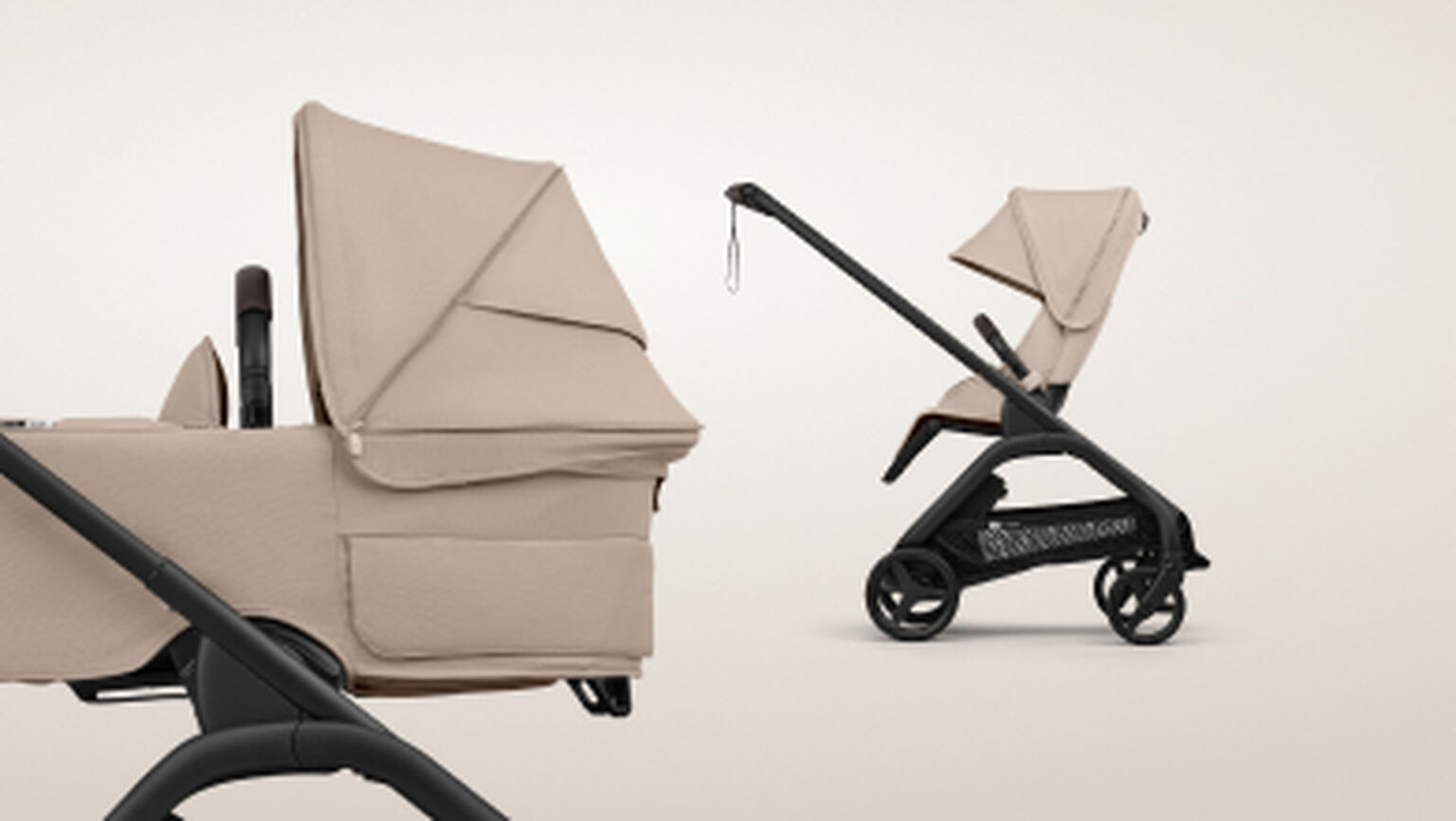 Two car seats side by side. On the left, a Bugaboo Otter by Nuna infant car seat in Desert Taupe fabrics. On the right, a Bugaboo Owl by Nuna convertible car seat in black fabrics, secured on a 360 base with the stability leg extended.