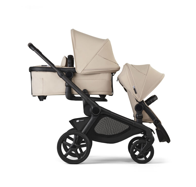 A Bugaboo Kangaroo tandem double stroller in Desert Taupe fabrics. A bassinet is in the upper position, facing the parent. A seat is in the lower position, facing the world.