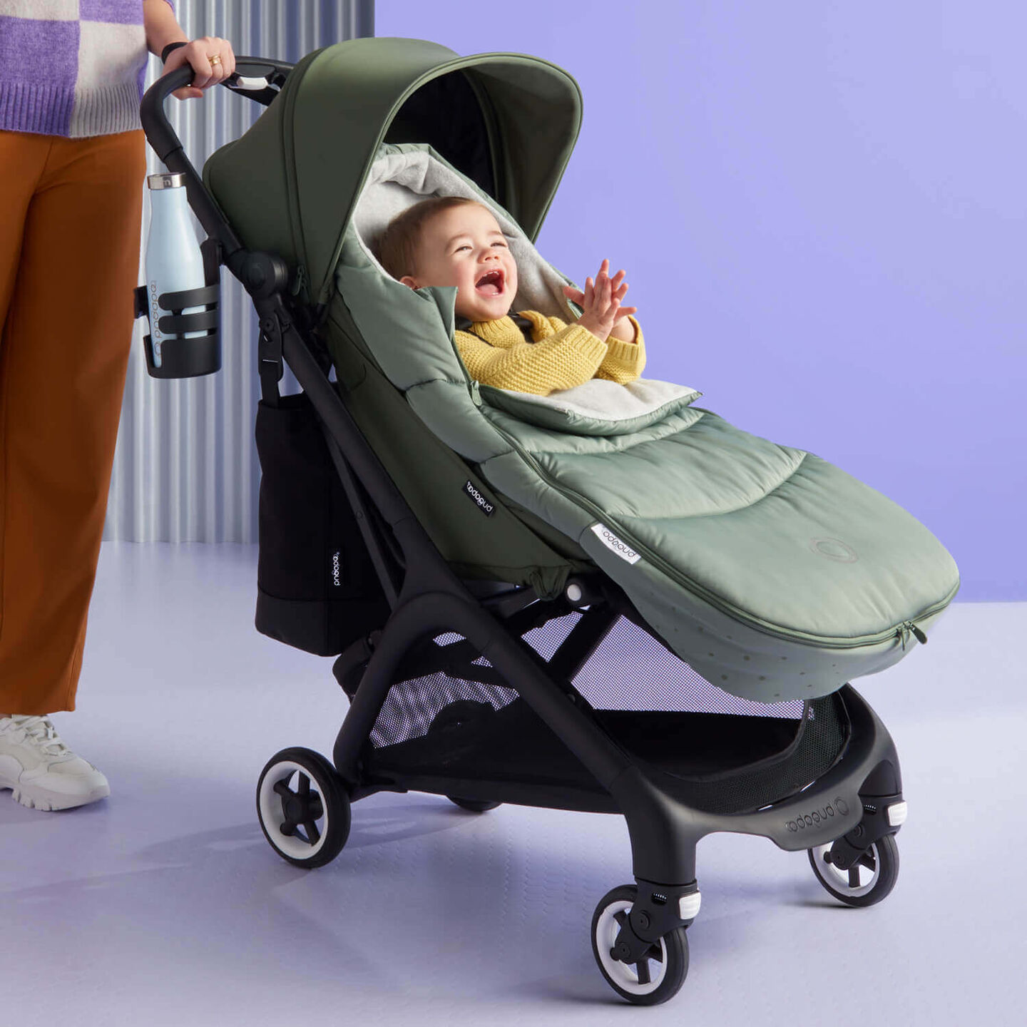 Baby snug inside a Bugaboo footmuff in a Butterfly stroller.