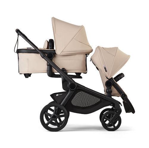 A Bugaboo Kangaroo tandem double stroller in Desert Taupe fabrics. A bassinet is in the upper position, facing the parent. A seat is in the lower position, facing the world.