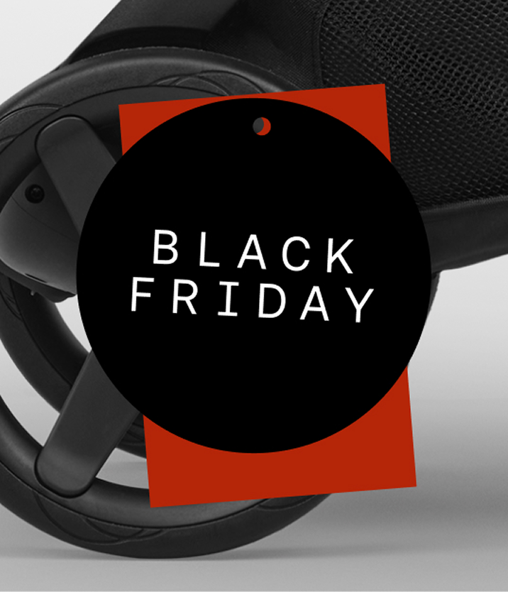 Close-up of a Bugaboo stroller wheel, below a red price-tag shape. On top is a black circular badge with the words “Black Friday” in white.