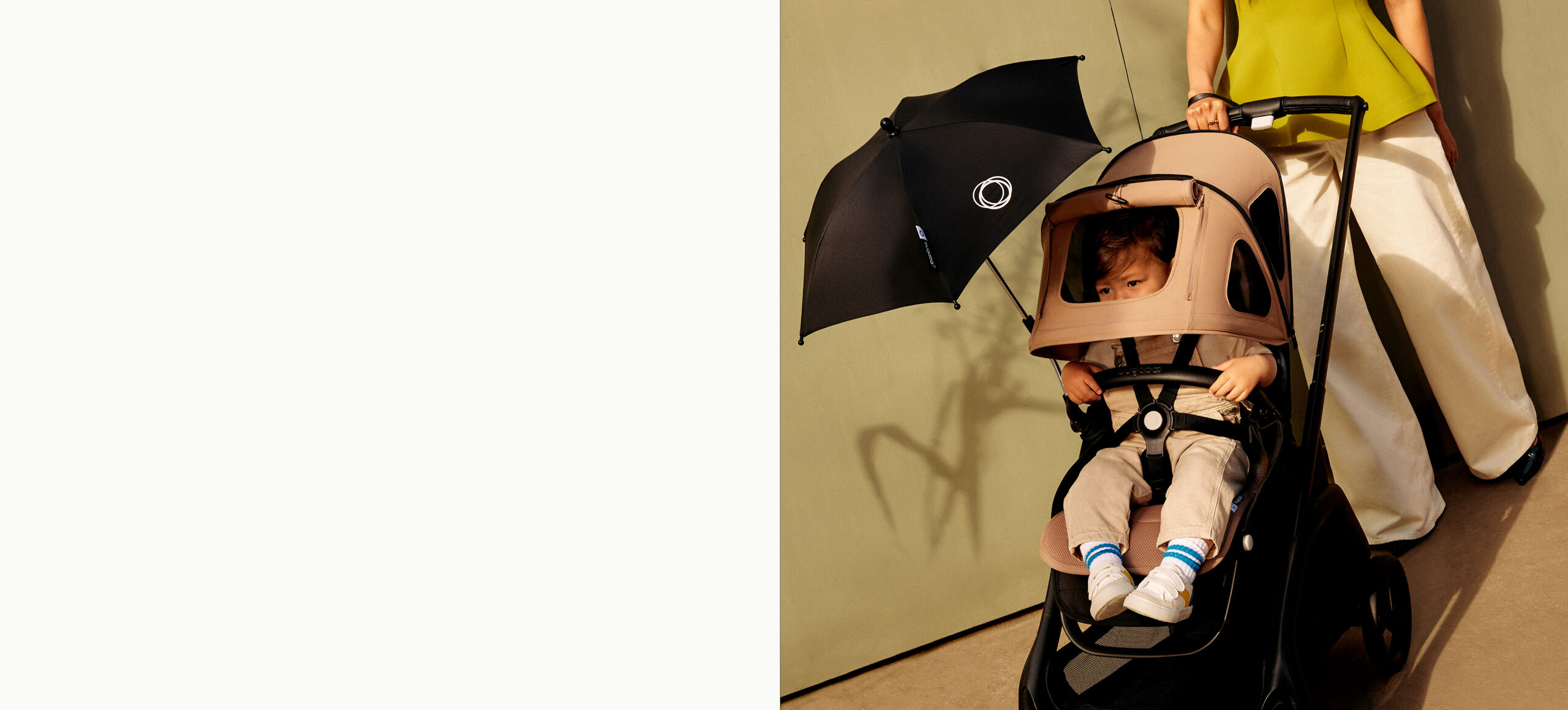 Mom pushing Bugaboo stroller with breezy sun canopy and parasol attached