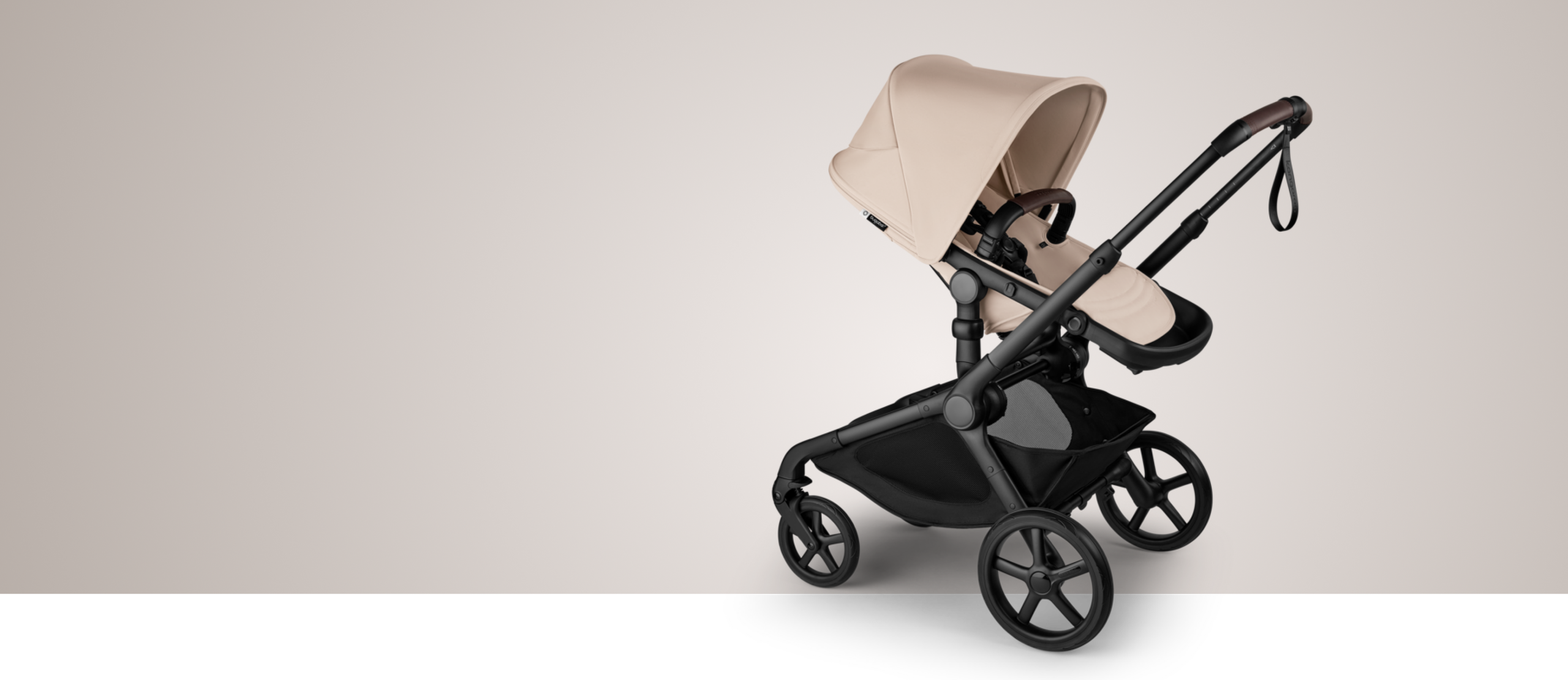 A Bugaboo Kangaroo single-to-double stroller in Desert Taupe fabrics, with a bassinet.