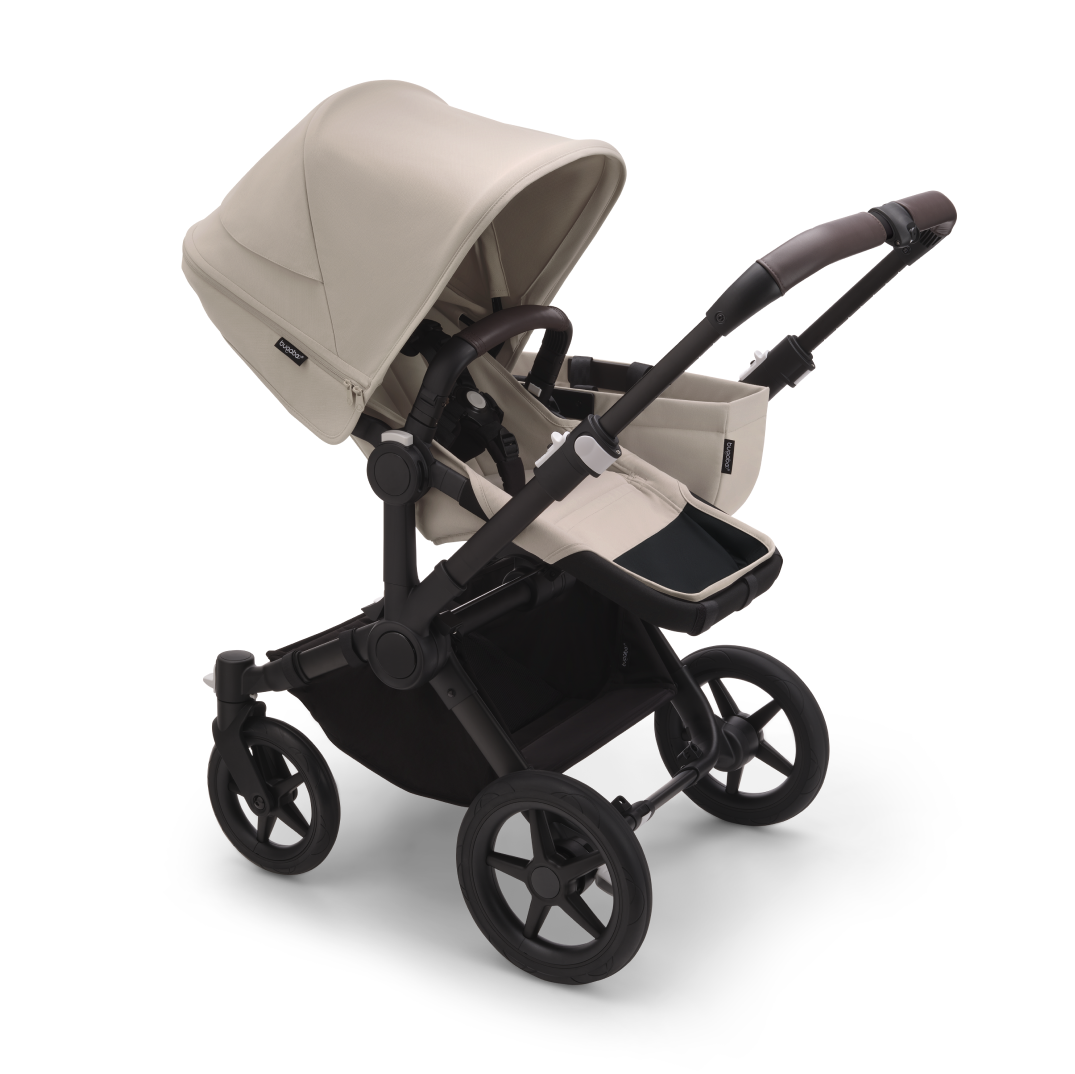 The Bugaboo Donkey 5 with Desert Taupe fabrics in Mono configuration, featuring a seat and a side luggage basket.