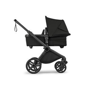 A side view of a Bugaboo Cub all-terrain bassinet stroller in Midnight Black fabrics.