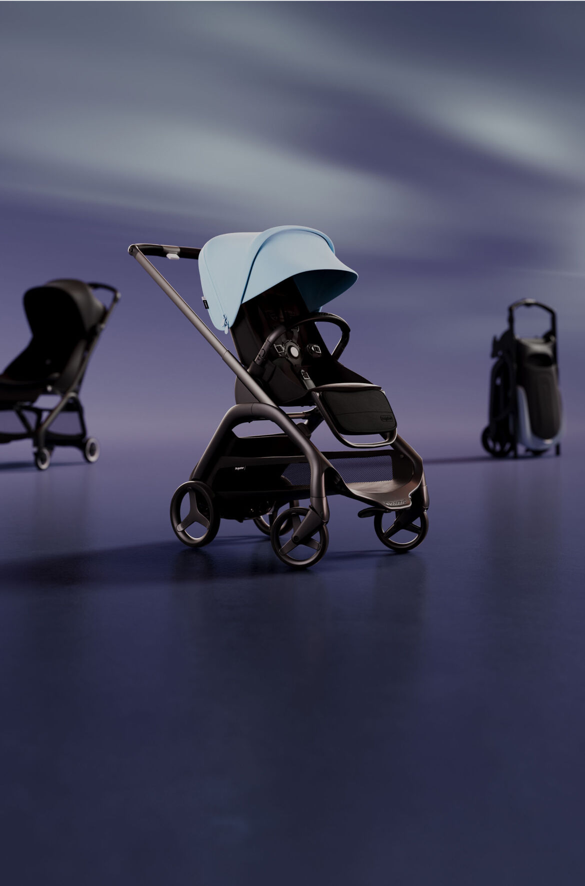 A lineup of 3 strollers. At the front is a Bugaboo Dragonfly with Skyline Blue sun canopy. On the left is a Bugaboo Butterfly with Midnight Black fabrics. On the right is a self-standing folded Bugaboo Dragonfly.